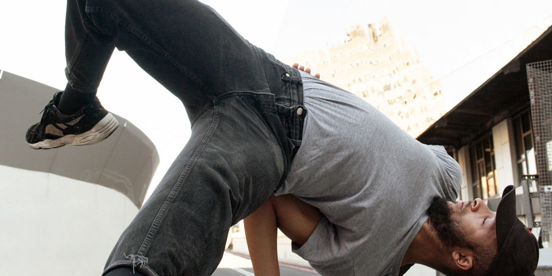 Street dancer doing a handstand in the street