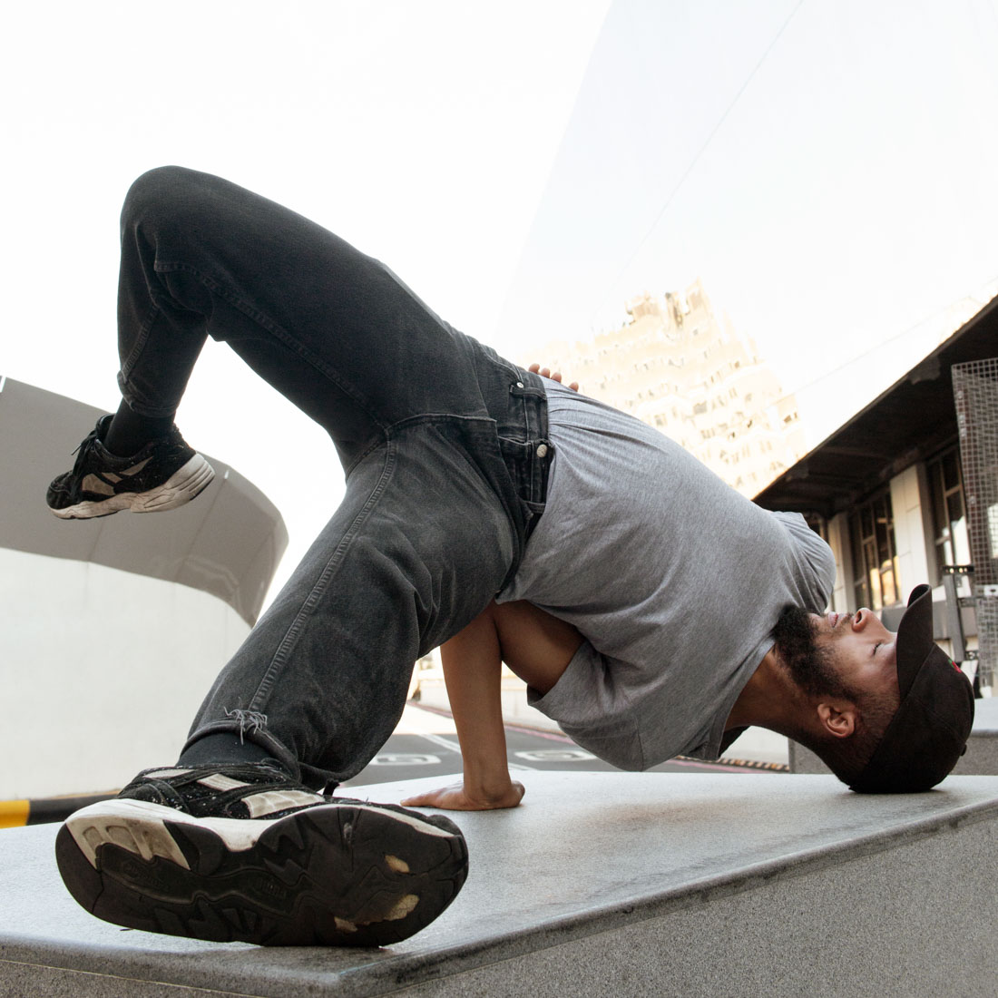 Street dancer doing a handstand in the street