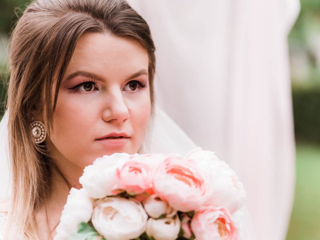 Portrait of a bride, bride holding wedding bouquet 