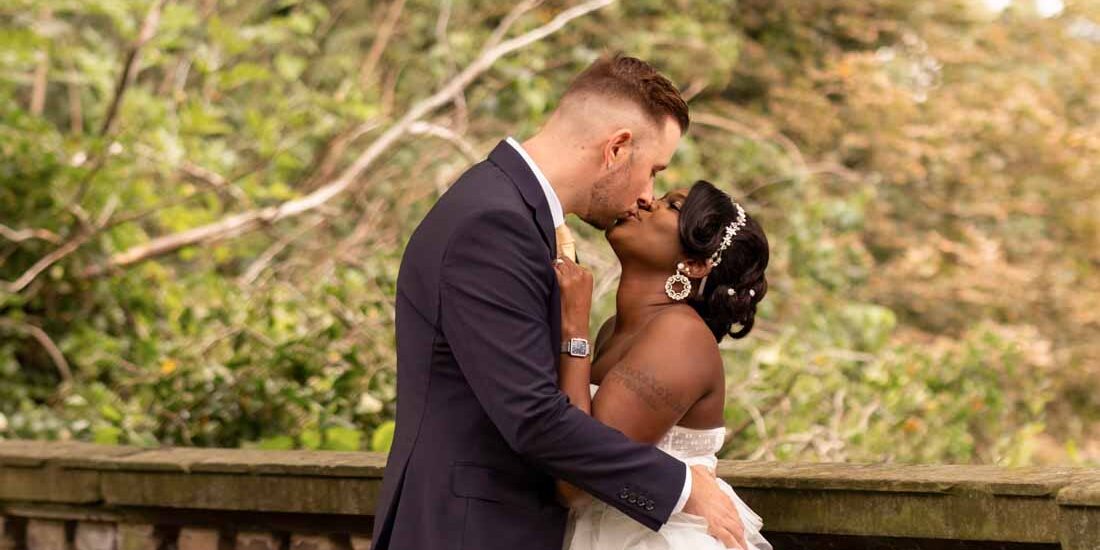 Bride and groom kissing under the tree. Wedding in Lichfield, Staffordshire.