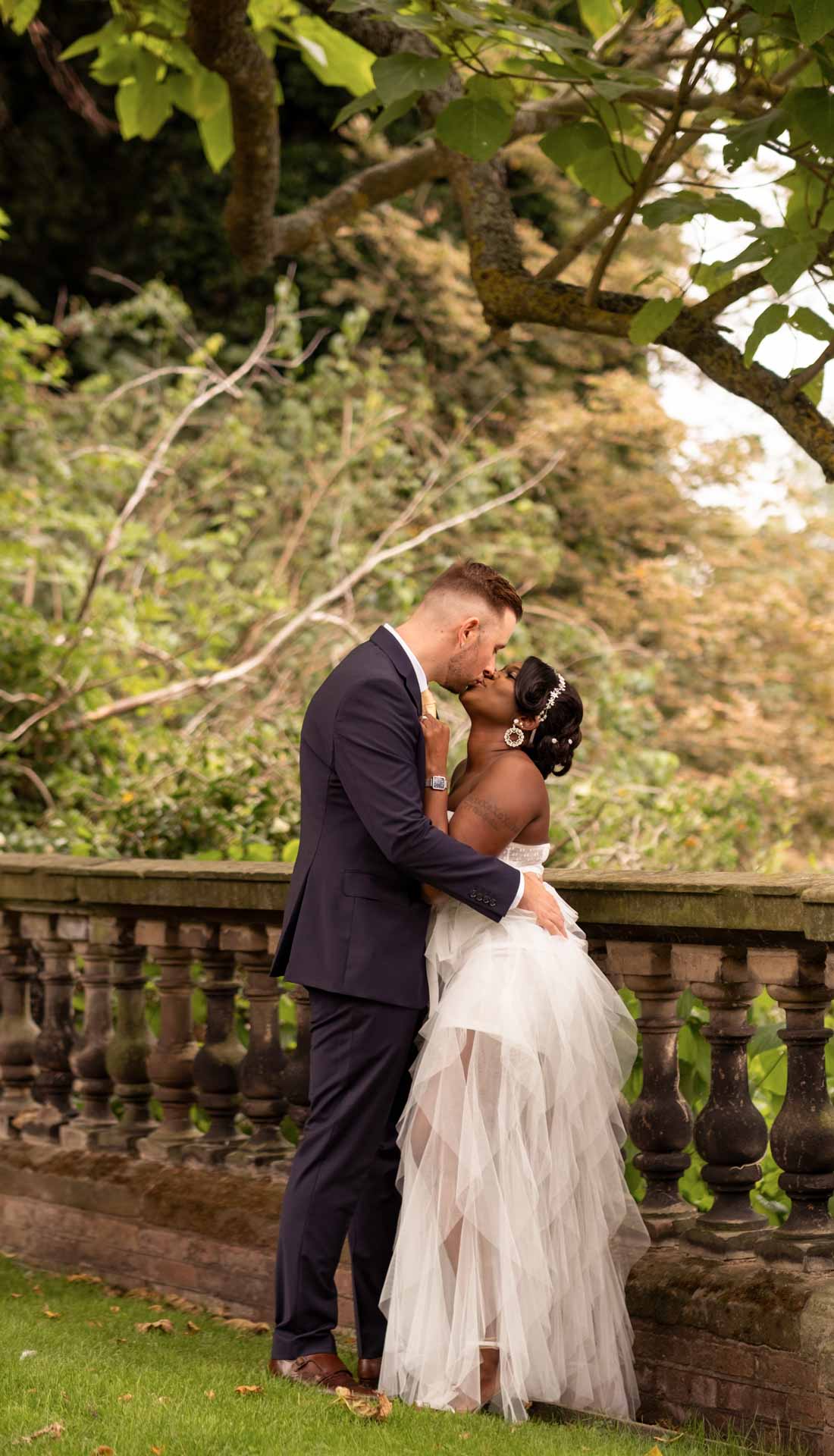 Bride and groom kissing under the tree. Wedding in Lichfield, Staffordshire.