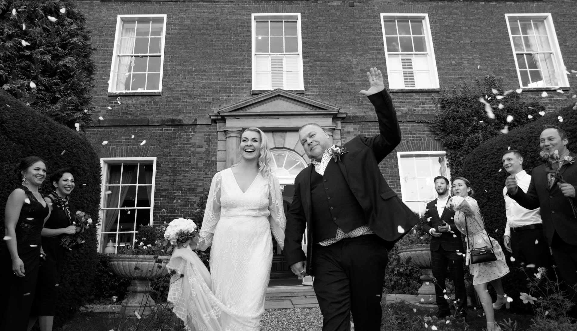 wedding confetti exit. Bride and groom walking through confetti in Dovercliff Hall Hotel