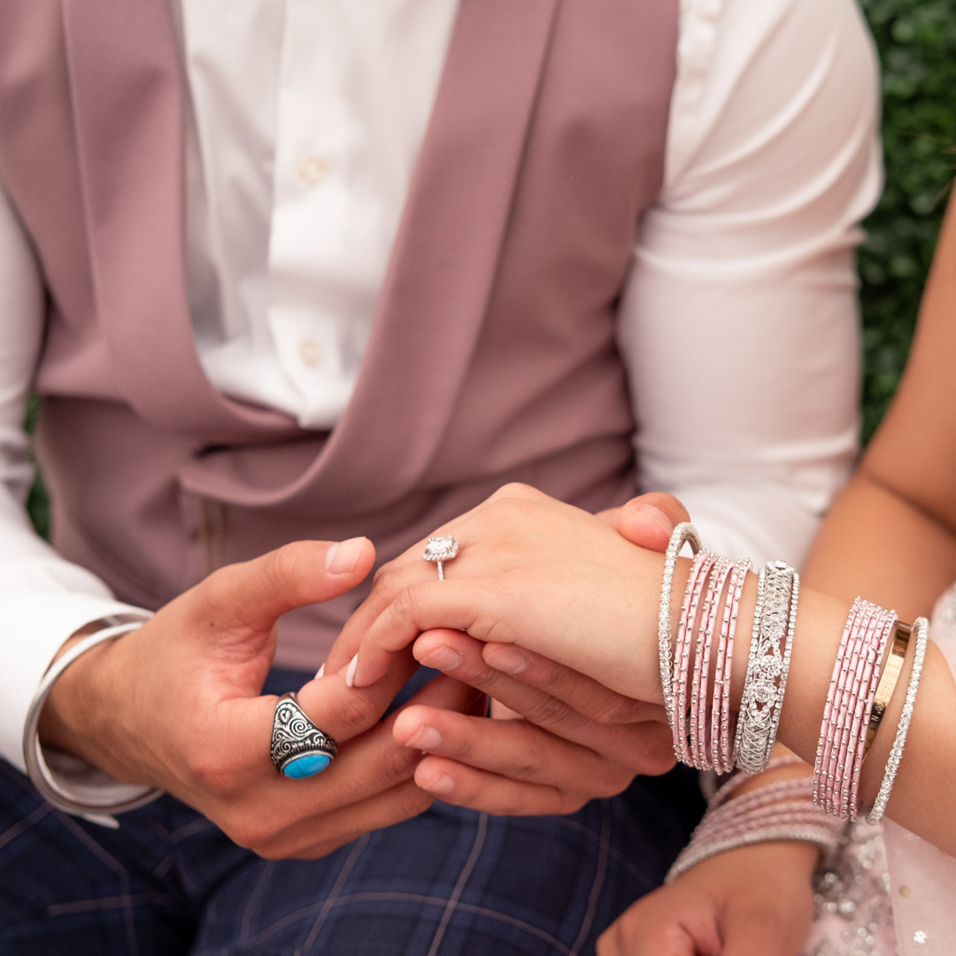 Close up photo of hands during a proposal at a Sikh engagement party