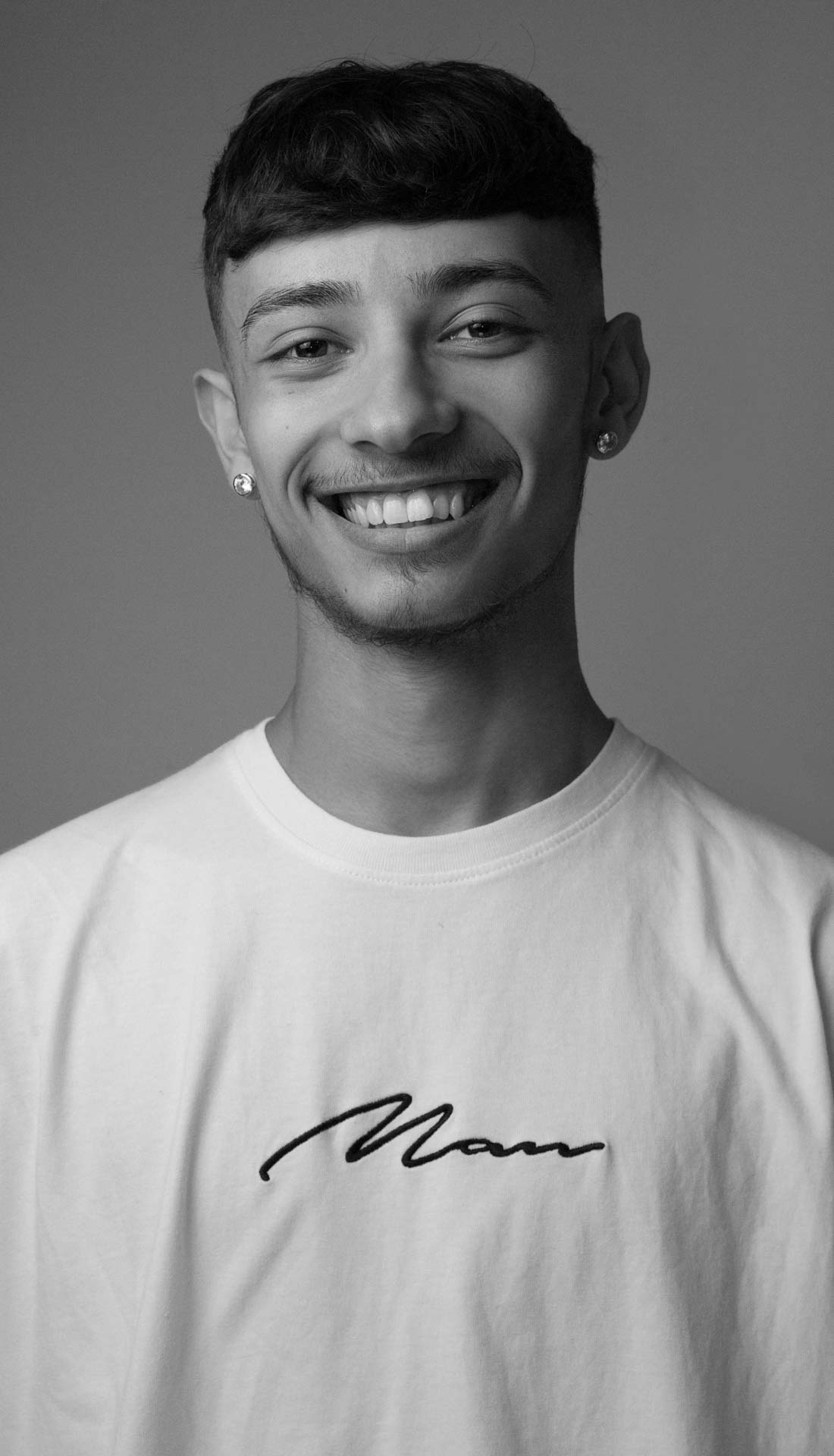 Actor and performer professional headshots Birmingham U.K. - A black and white portrait of a young man wearing white top saying 'nan'
