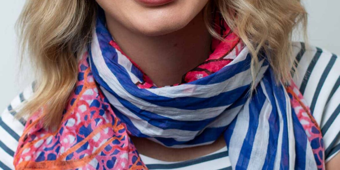 blond woman smiling professional headshot for LinkedIn profile photo white wall
