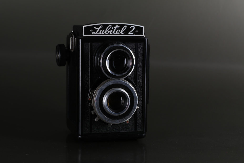 Vintage 120mm film camera Lubitel 2 on plain grey background