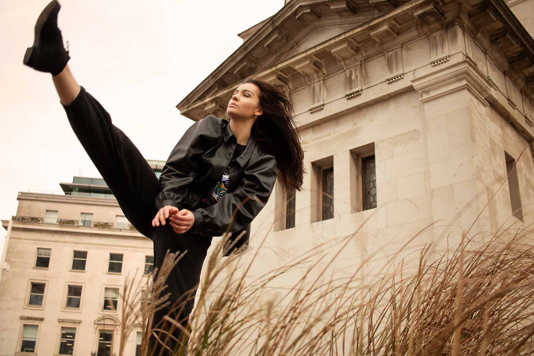 Dance photography poses, how to pose dancers for photos: An action photo of a dancer throwing her leg up in the air