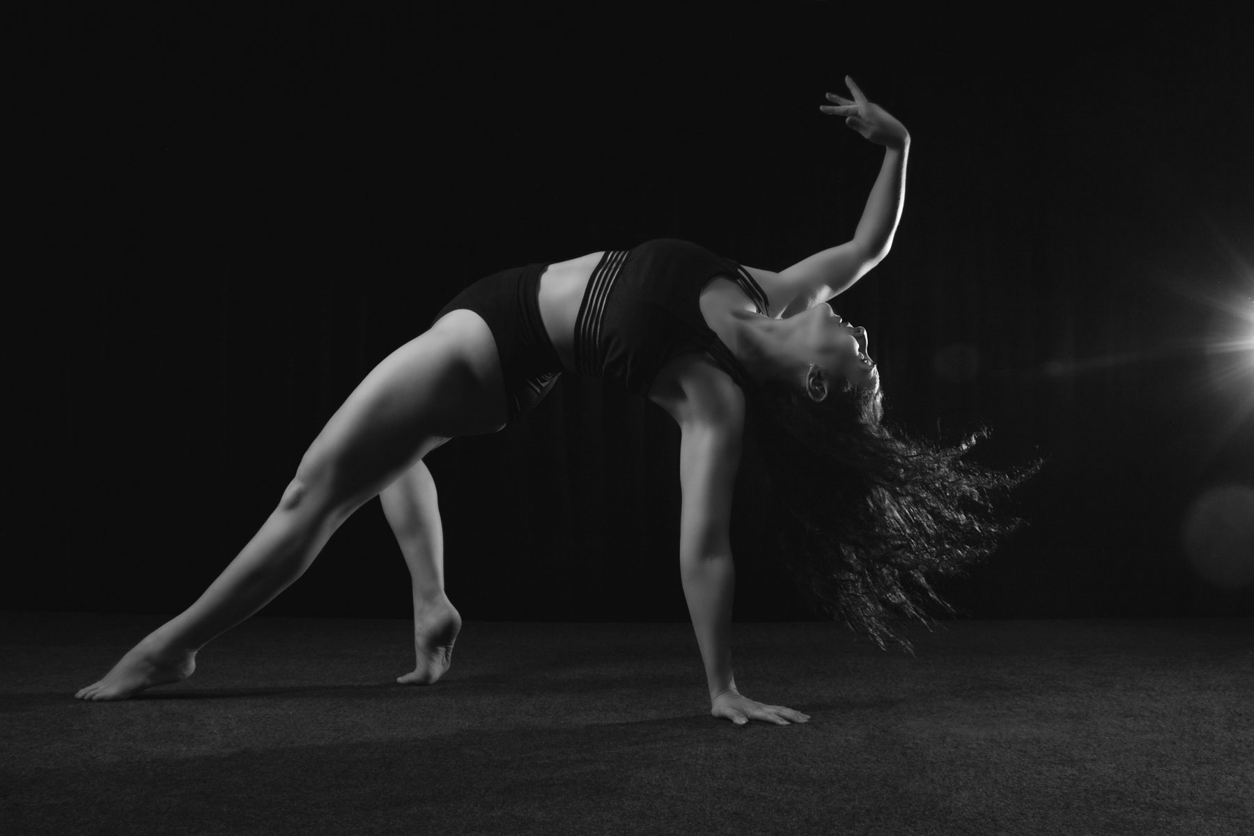 A dancer is whipping her hair in the floor movement, a guide to dance photography poses. Photography blog