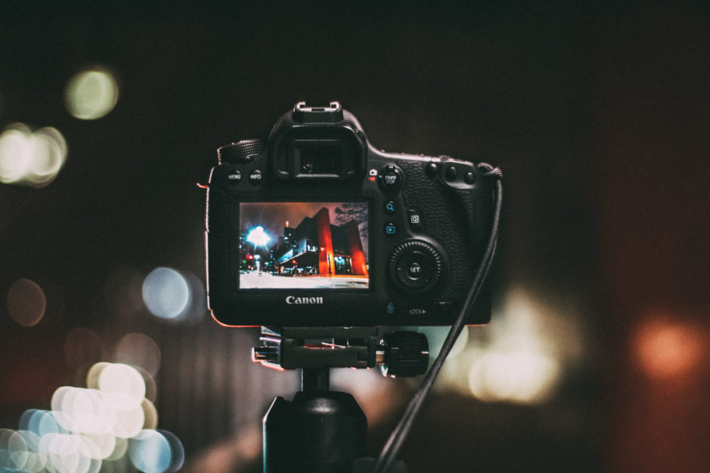 TikTok for photographers. A Canon camera on a tripod taking image of a city at night