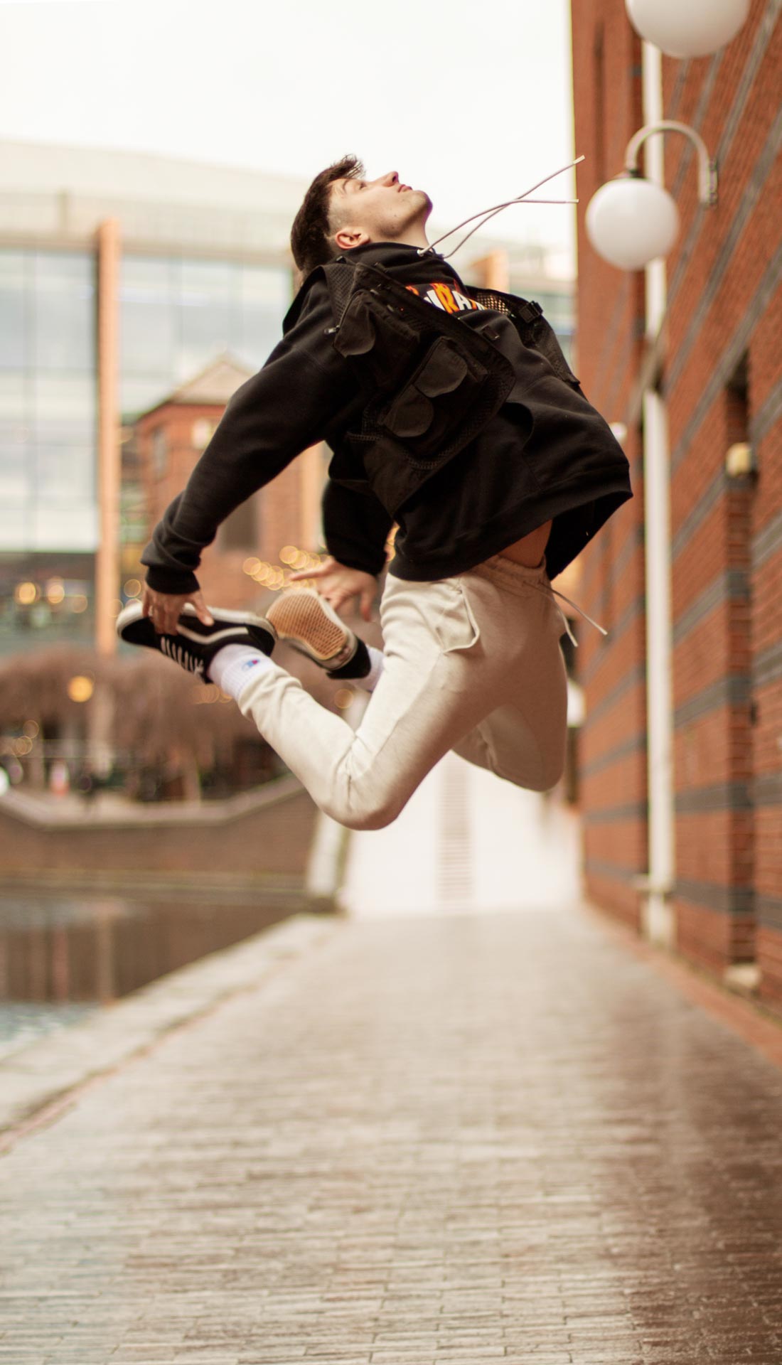 Male dancer doing a dramatic leap in the street in Birmingham. Personal branding photography for dancers