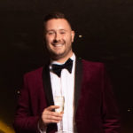 man wearing smoking drinking champagne