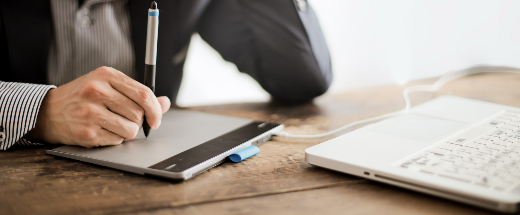 man using a graphics tablet for photo editing