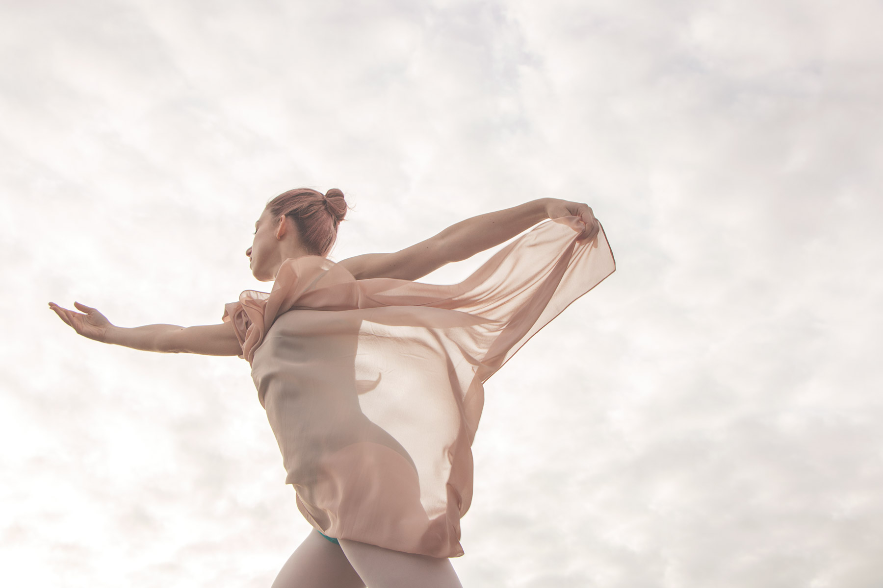 Ballerina dancing wrapped in fabric cloth. Creative dance photography, dance photography tips, dance photography UK