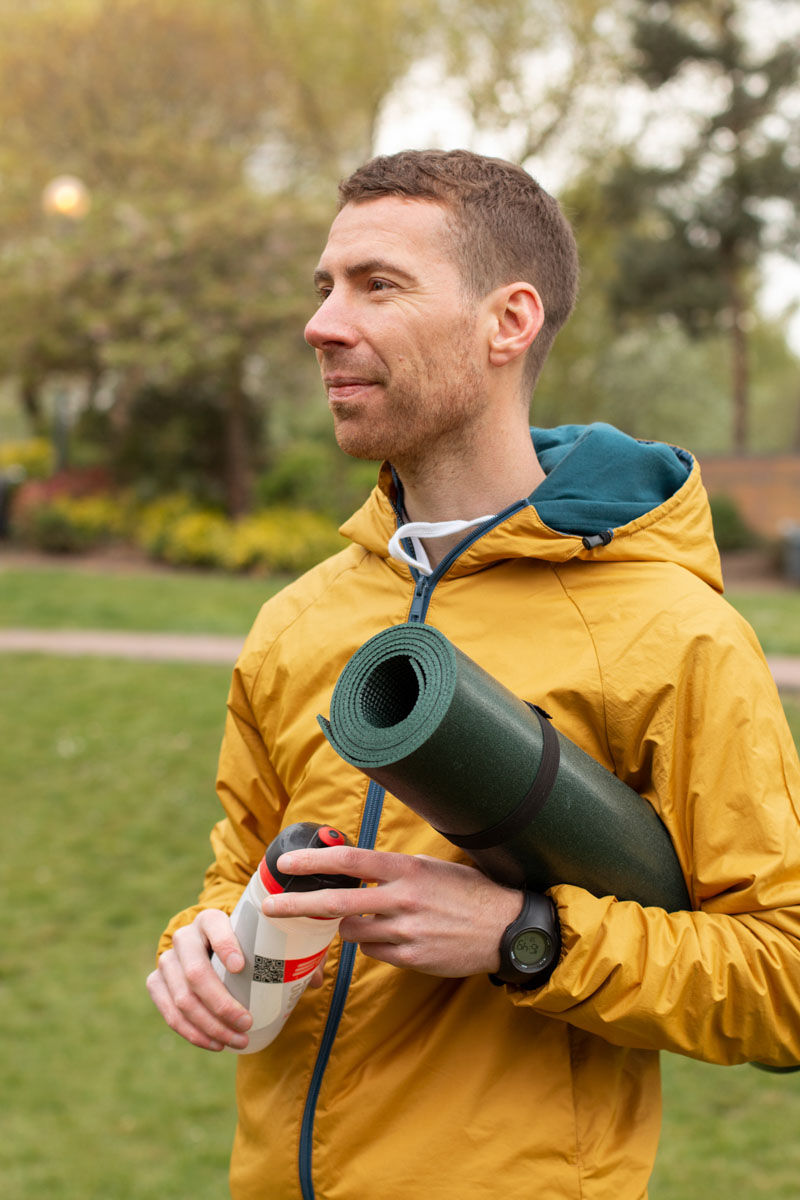 outdoor lifestyle photoshoot in Birmingham city centre. Man holding a water bottle and a yoga mat