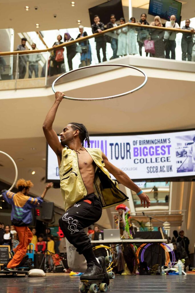 Fierce Flow show at Bullring during Birmingham Weekender 2021, male roller skater performing with a hula hoop