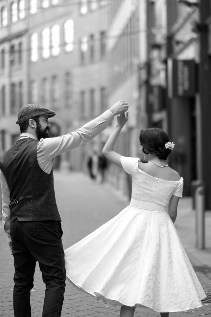 Couple dancing on the street on their wedding day