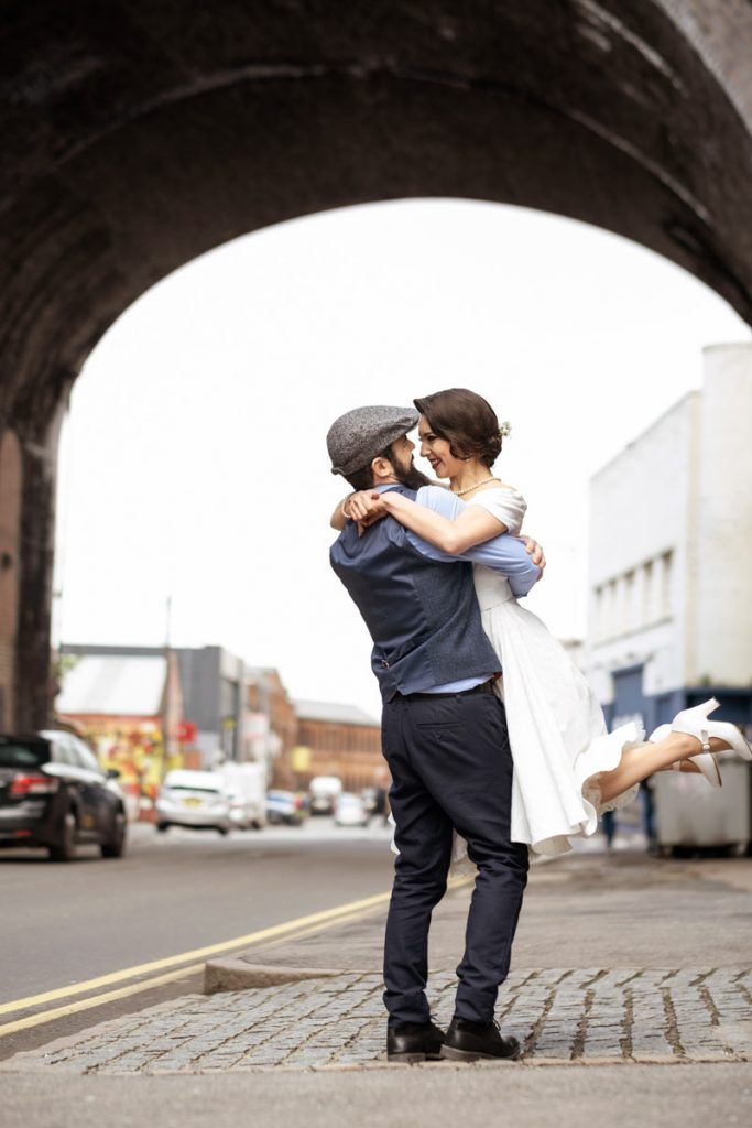 Groom holding his bride in his arms. Vintage wedding photoshoot in Birmingham 