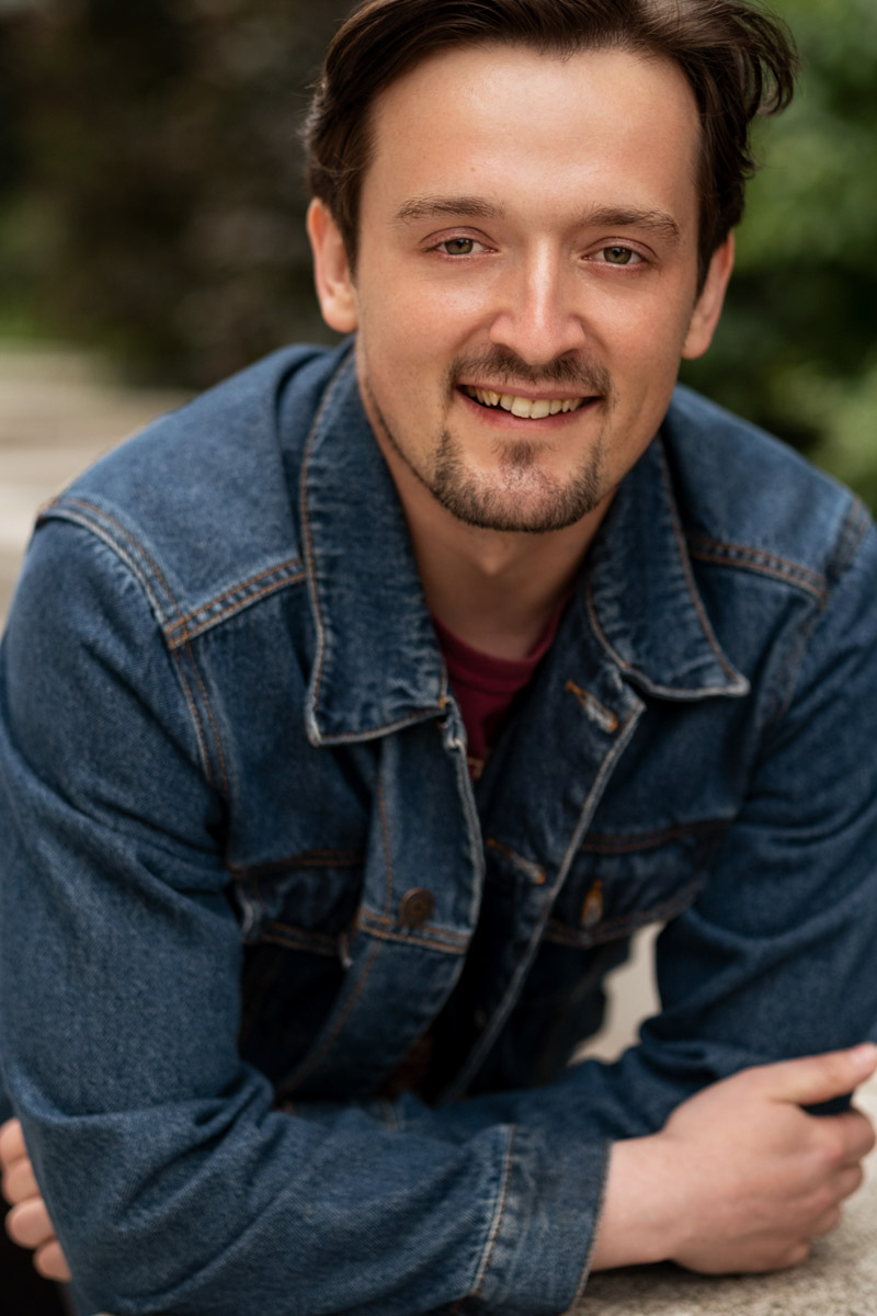 Lifestyle outdoor headshot portrait of a man smiling