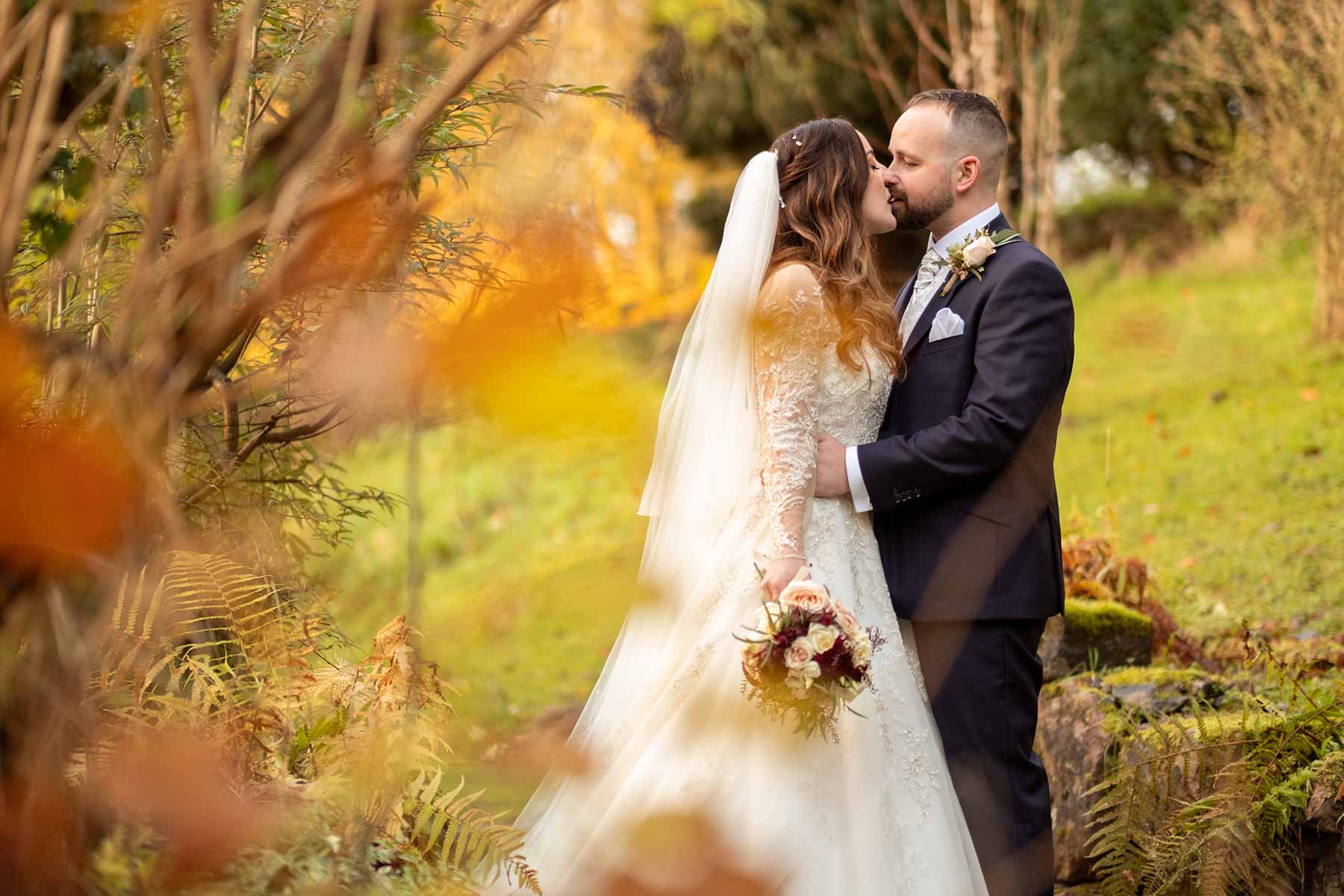 Bride and groom kissing, weddingphotography at Mill Barns,  