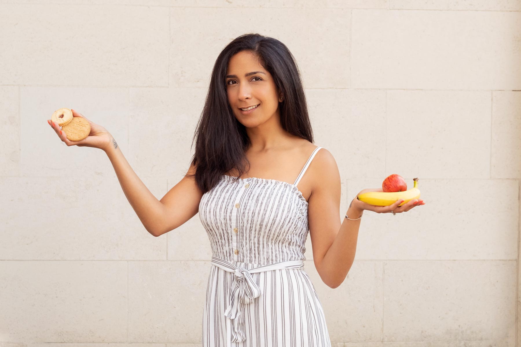 Nutritionist holding fruit and biscuits. Branding photography for a Birmingham nutrition expert. Updating your branding photography as a business New Year's resolution for 2022