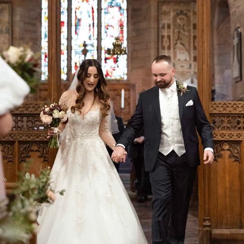 Bride and groom walking down the isle in the church