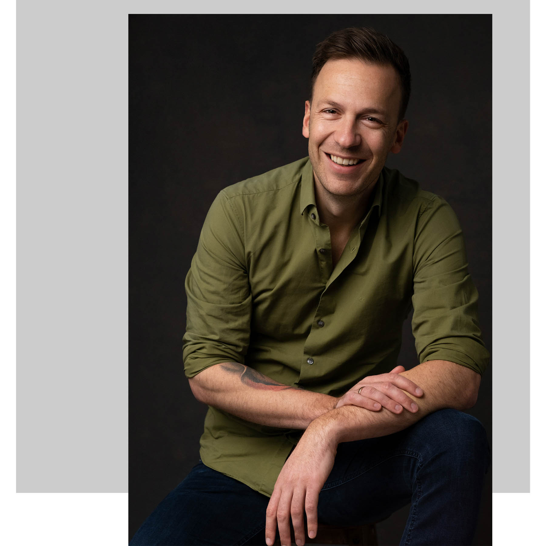 a studio business portrait of a man smiling