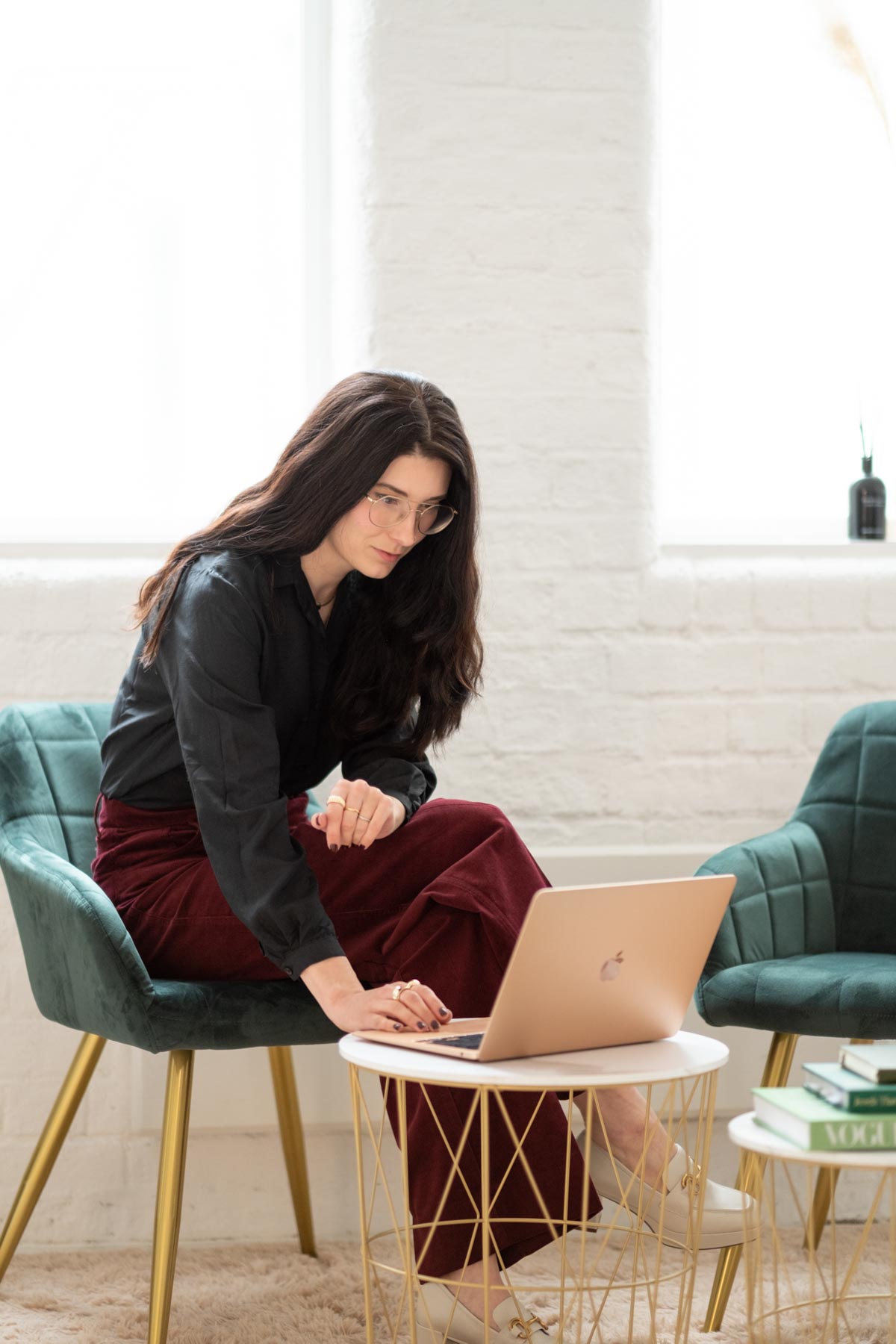 a woman typing on the laptop