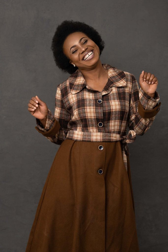 woman dancing and smiling during a studio portrait photoshoot