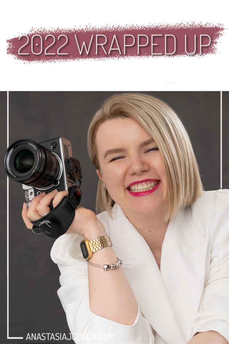 blond female Birmingham photographer smiling and holding a camera