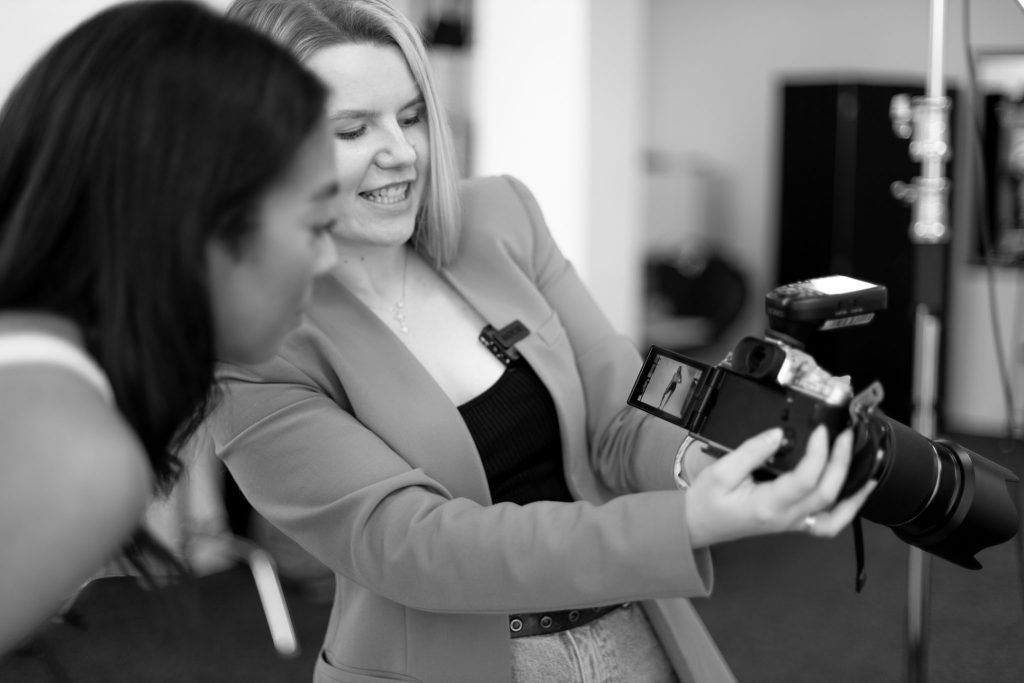 behind the scenes of a fitness branding photoshoot with a fitness trainer, photo review