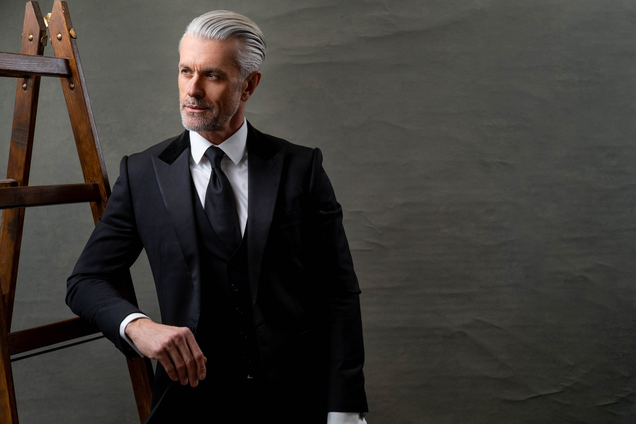 grey haired man wearing a classic 3-piece men suit fashion clothing photography photoshoot