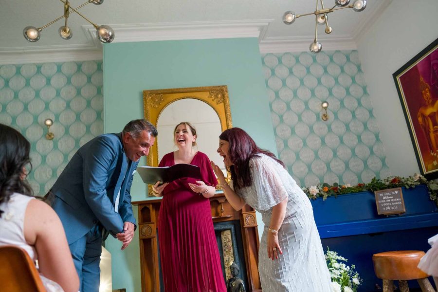 vow renewal, a couple and registrar laughing during wedding ceremony