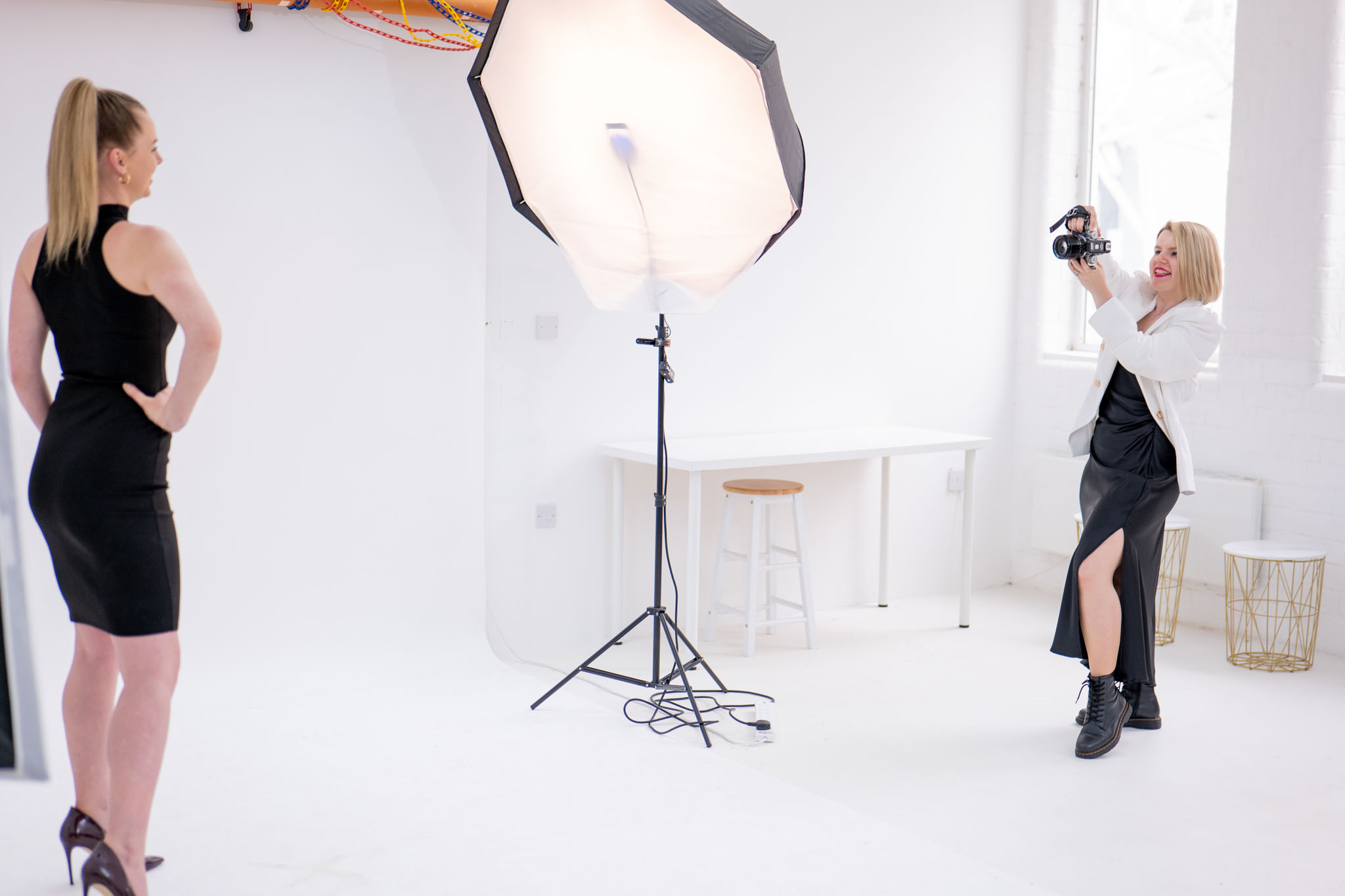 backstage of a branding photography session, photographer smiling while taking a photo