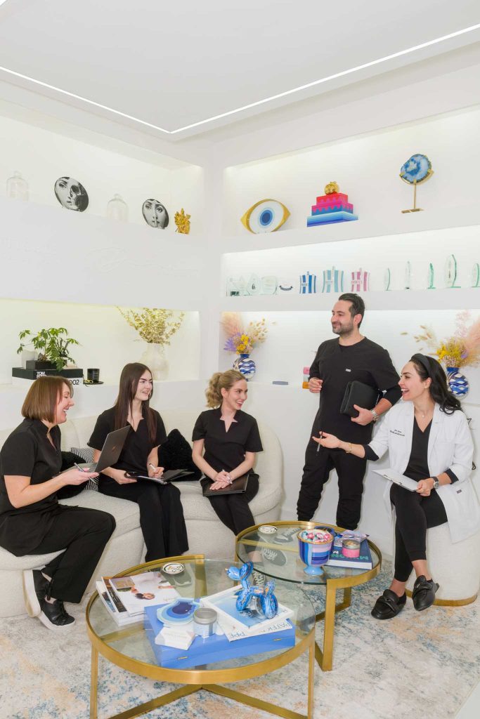 aesthetic clinic team photo, team members are talking and laughing