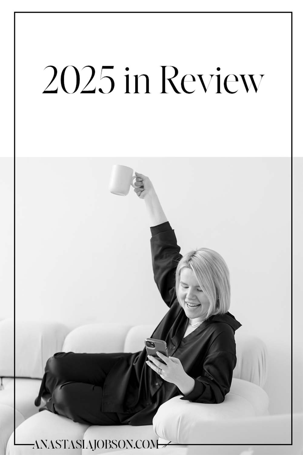 female commercial photographer raising a mug and looking at the phone smiling