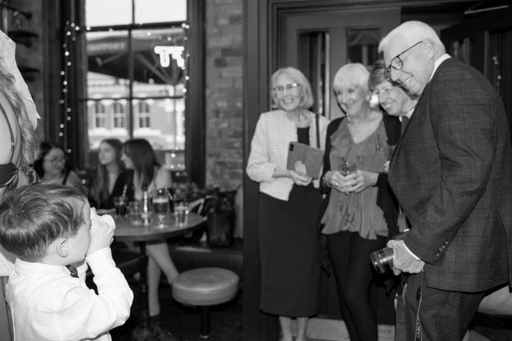 family occasion, event photography in Birmingham, family posing for a polaroid picture