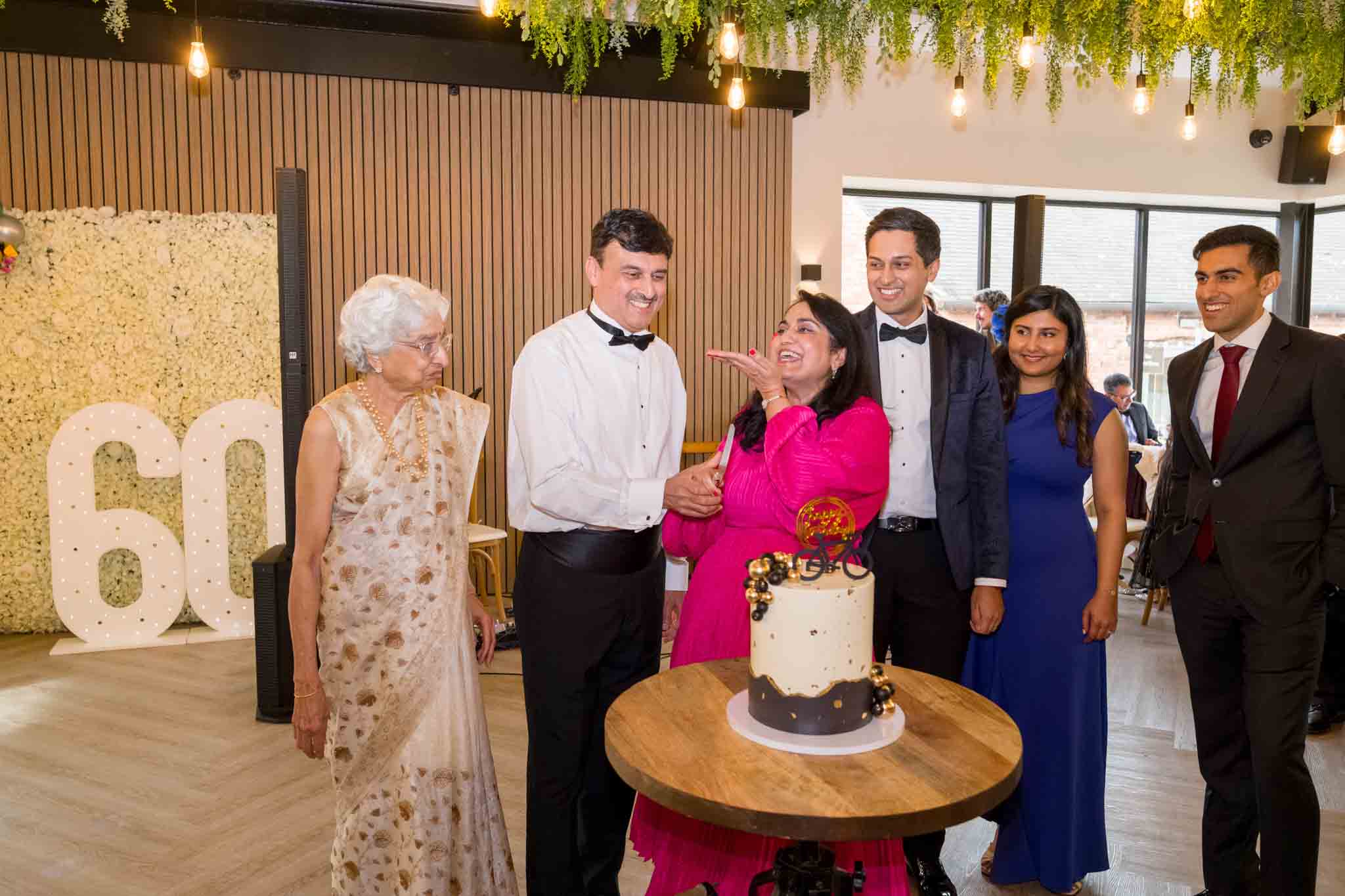 a 60th birthday party photography, cutting cake